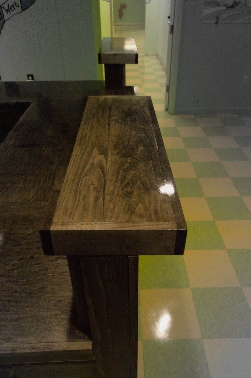 Custom Made Lobby Desk and Reception side view of high bar shelf